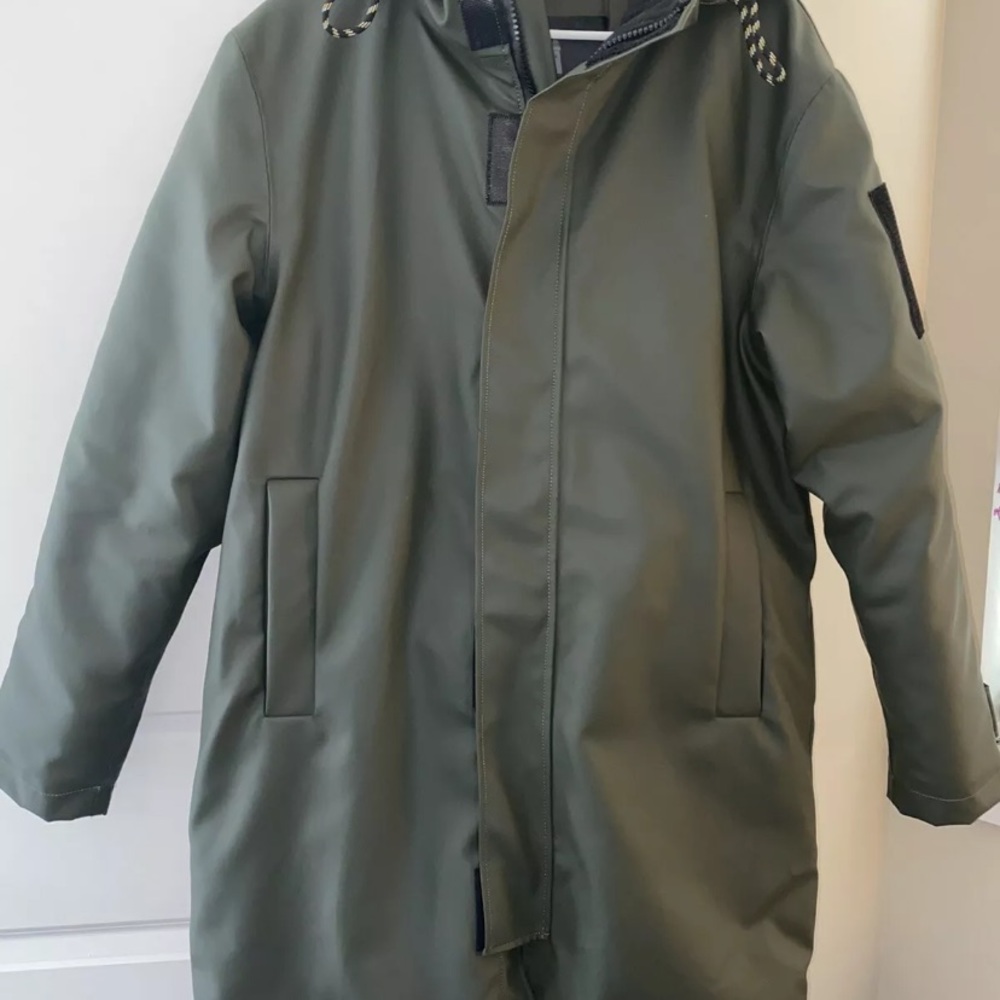 Women’s above the knee, insulated, dark green glacial parka